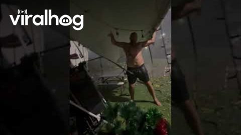 Man Holds Down Awning to Help Family Get to Safety || ViralHog