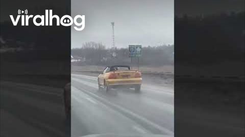 Convertible With Its Top Down in a Freezing Rain Storm || ViralHog