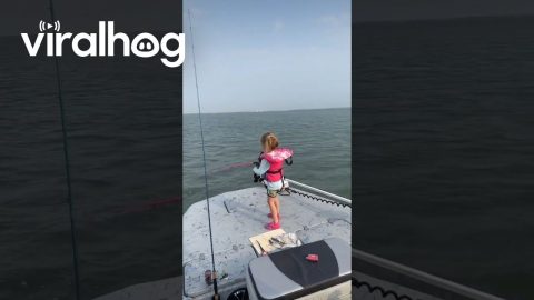Girl Holds on Tight While Reeling in Fish || ViralHog