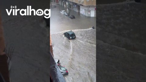 Car Drives Through Flooded Street in Spain || ViralHog