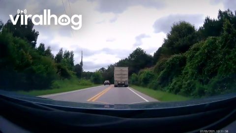 Driver Attempts Passing Truck on Blind Corner || ViralHog