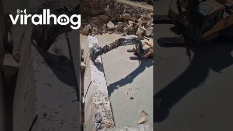 Excavator Knocks Down Travertine Wall || ViralHog