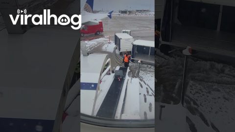 Airplane Luggage Keeps Sliding Down Icy Conveyor Belt || ViralHog