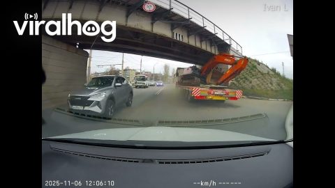 Truck Carrying Construction Equipment Gets Lodged Under Railway Bridge || ViralHog