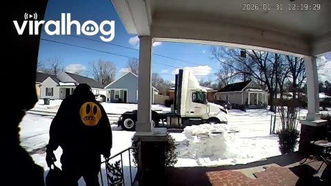 Truck Driver Slips on Ice While Carrying Paintball Tanks || ViralHog